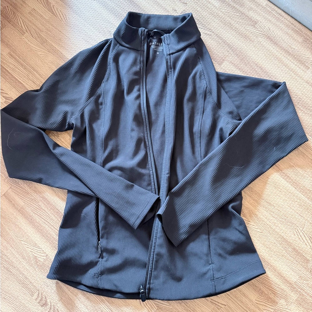 Athleta full zip jacket. Blacked ribbed material.